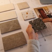 Interior designer choosing samples of floor tiles for project